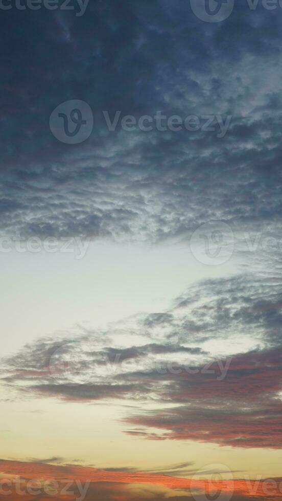 The beautiful sunset view with the buildings' silhouette and orange color sky as background in the city photo