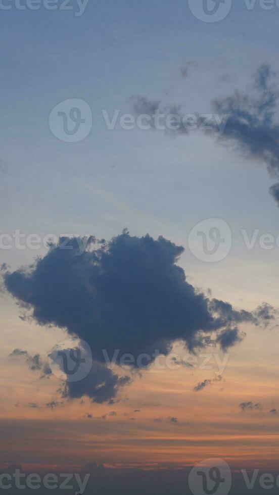The beautiful sunset view with the buildings' silhouette and orange color sky as background in the city photo