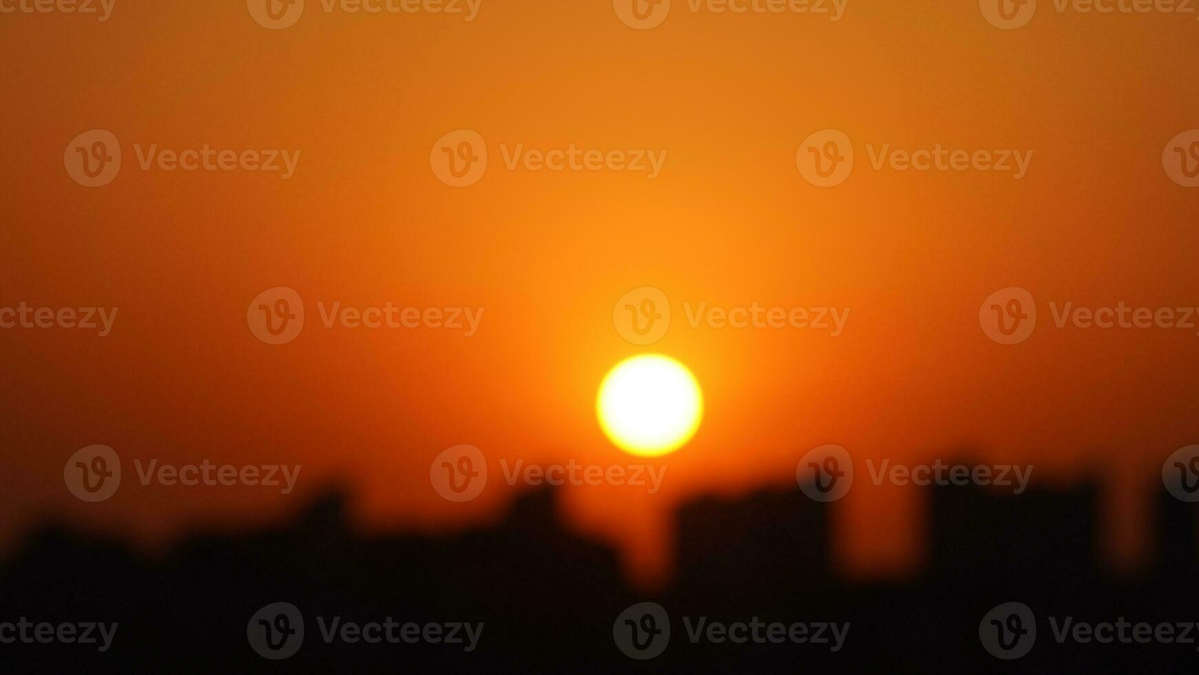 The blurred sunset view with the orange color in the sky photo