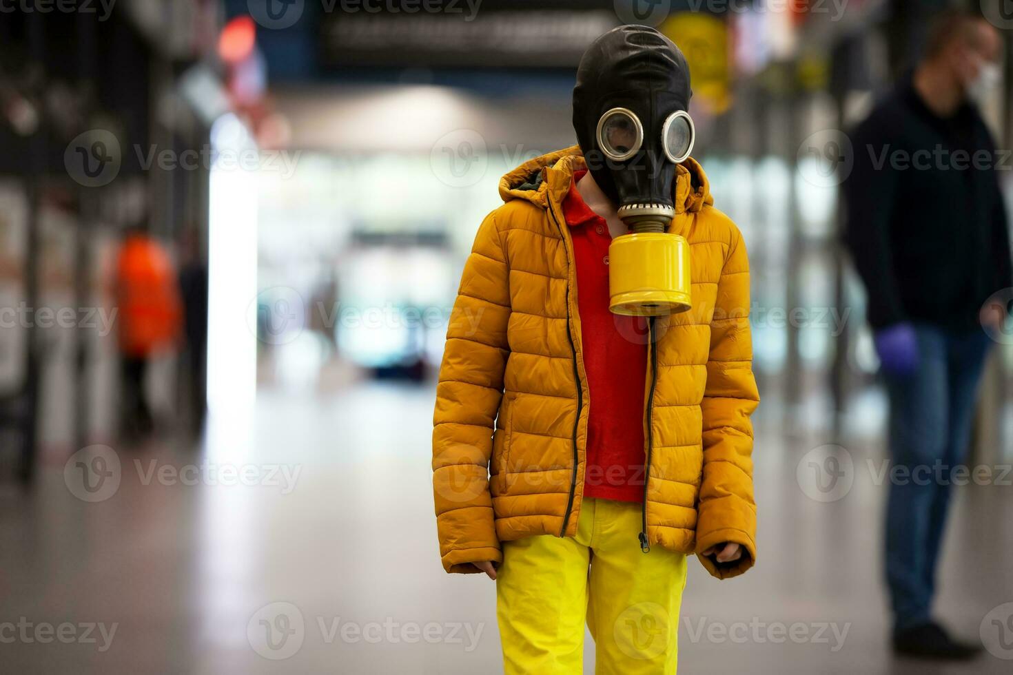 Coronovirus protection. A child in a gas mask with a coronovirus infection. Boy in a store in personal protective equipment. Man defends himself against COVID 19 photo