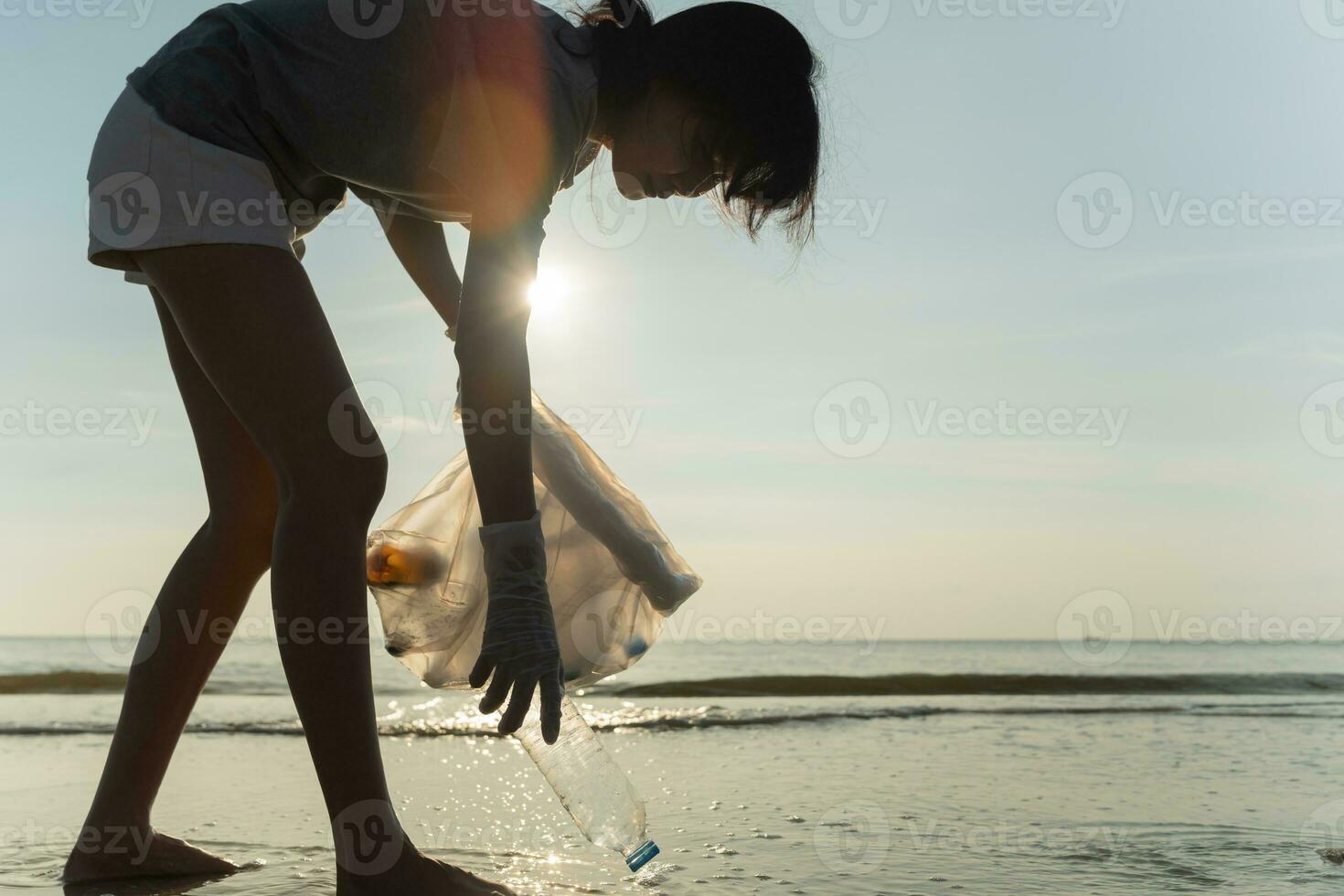 Save water. Volunteer pick up trash garbage at the beach and plastic bottles are difficult decompose prevent harm aquatic life. Earth, Environment, Greening planet, reduce global warming, Save world photo