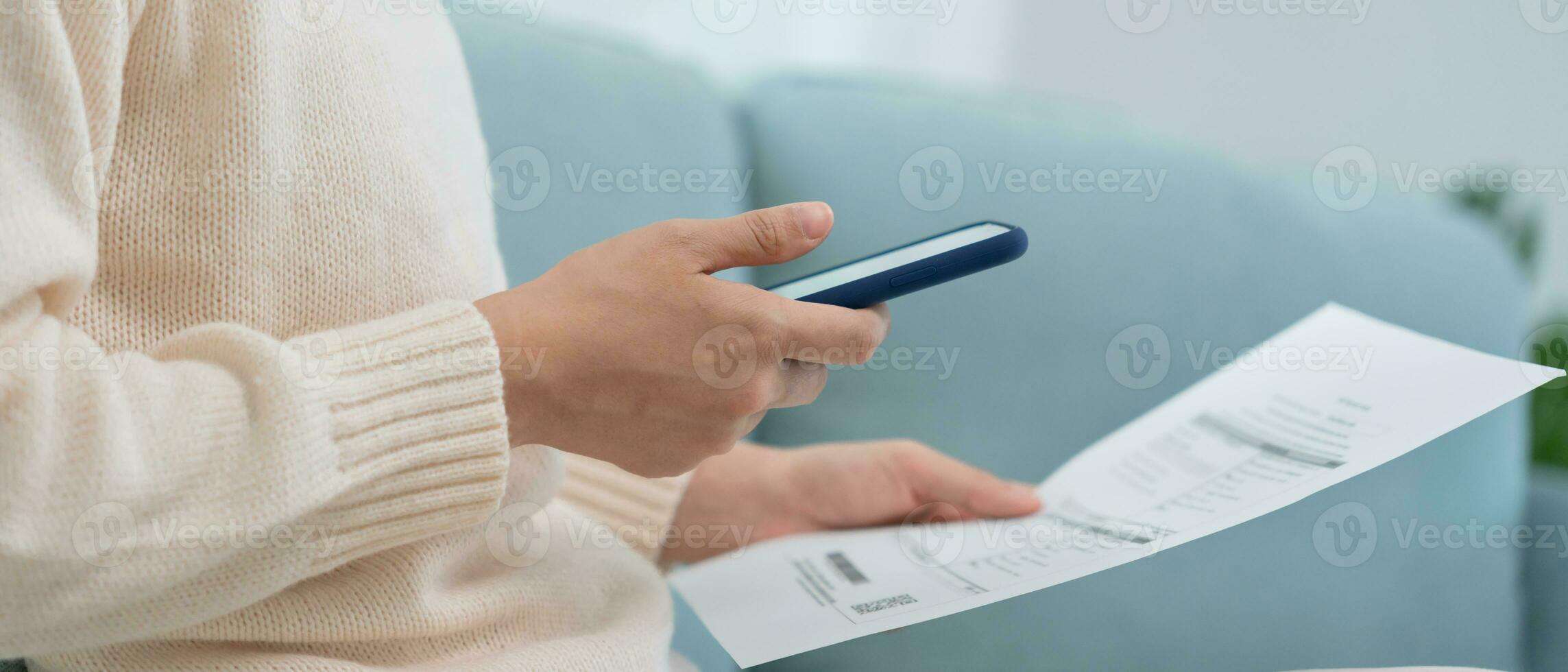 woman use phone scan barcode or QR codes to pay credit card bill after receiving document invoice. payment, receive, paying electricity, digital payments, technology, scanning, financial transactions photo