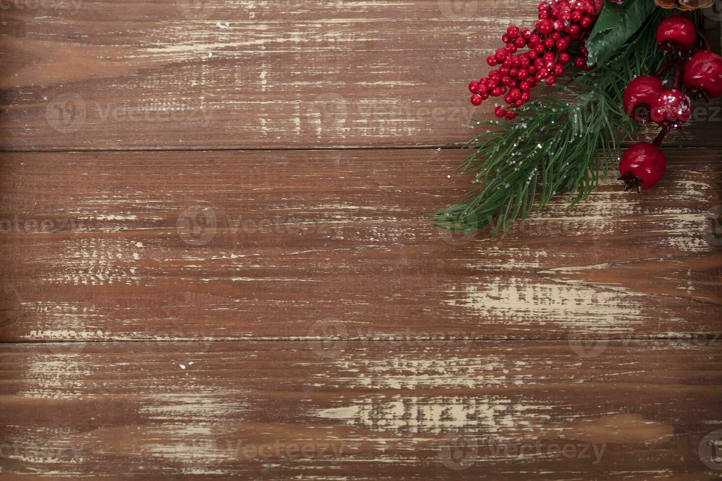 On a wooden background, a decoration of a fir branch and cones. Christmas background. photo
