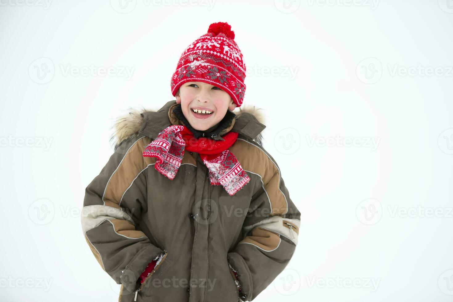 Child in winter. Cheerful boy in winter clothes smiles. photo