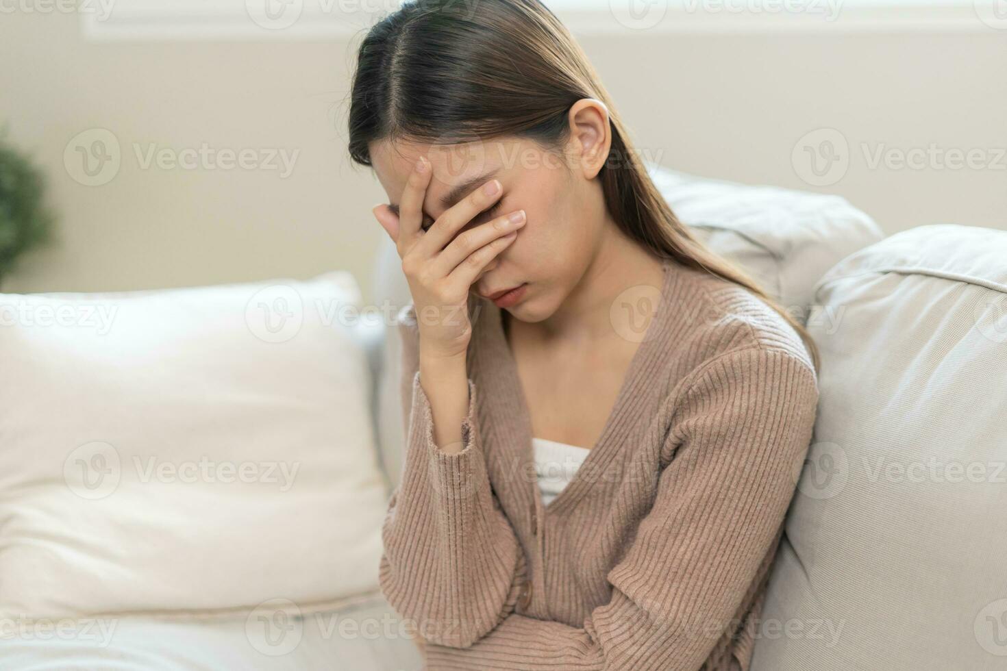 Depression and mental illness. Asian woman disappointed, sad after receiving bad news. Stressed girl confused with unhappy problems, arguing with boyfriend, cry and worry about unexpected pregnancy. photo