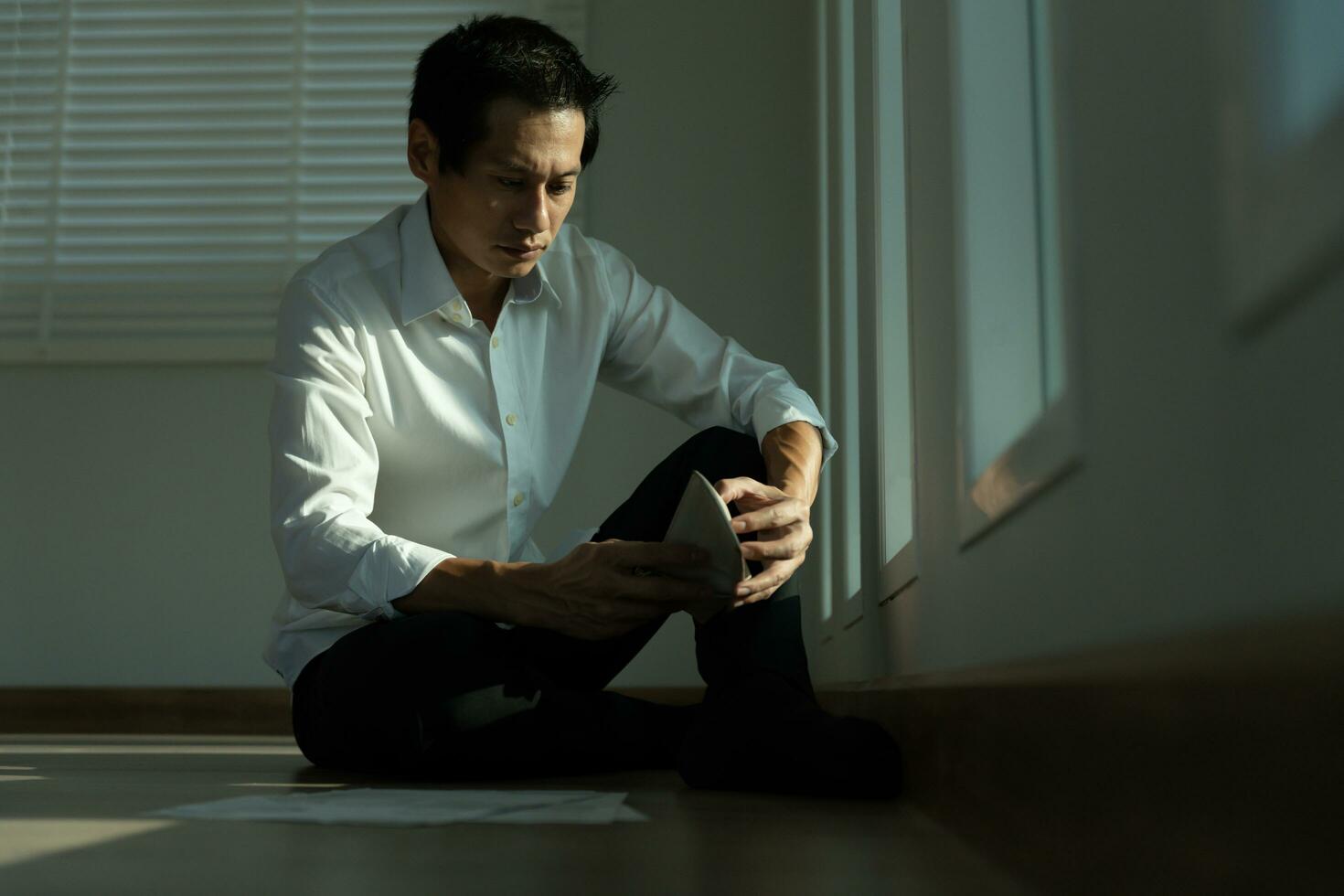 Stressed and headache asian man with large bills or invoices no money to pay to expenses and credit card debt. shortage, Financial problems, mortgage, loan, bankruptcy, bankrupt, poor, empty wallet photo