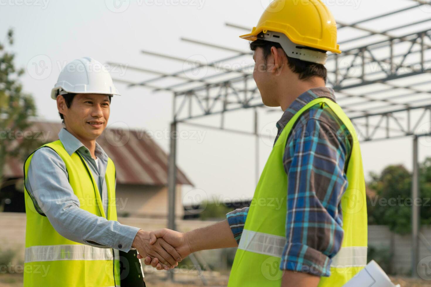 Construction worker team hands shaking greeting start up plan new project contract in office center at construction site, industry ,architecture, partner, teamwork, agreement, property, contacts. photo