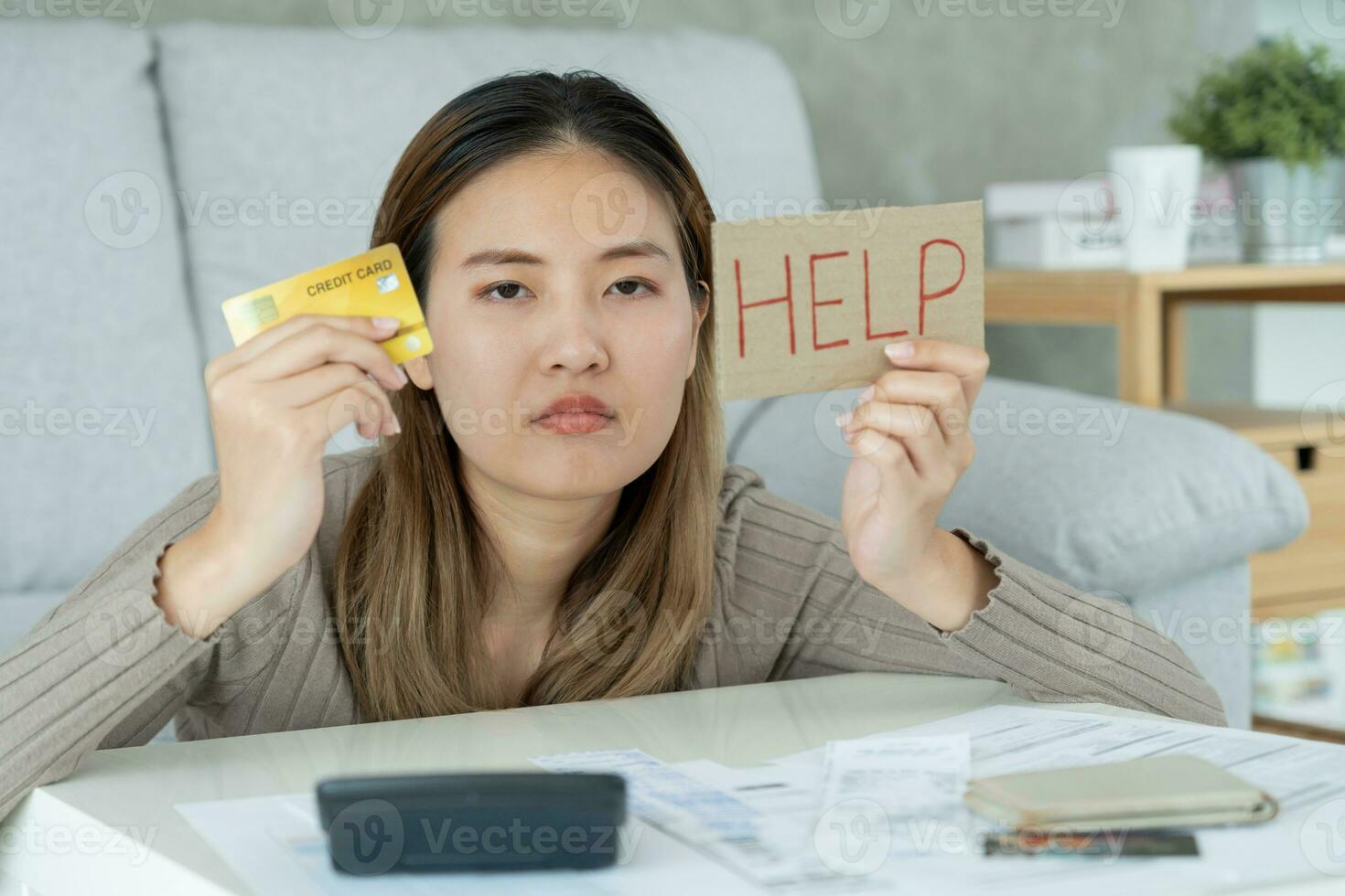 Stressed and headache asian woman with large bills or invoices no money to pay to expenses and credit card debt. shortage, Financial problems, mortgage, loan, bankruptcy, bankrupt, poor, empty wallet photo