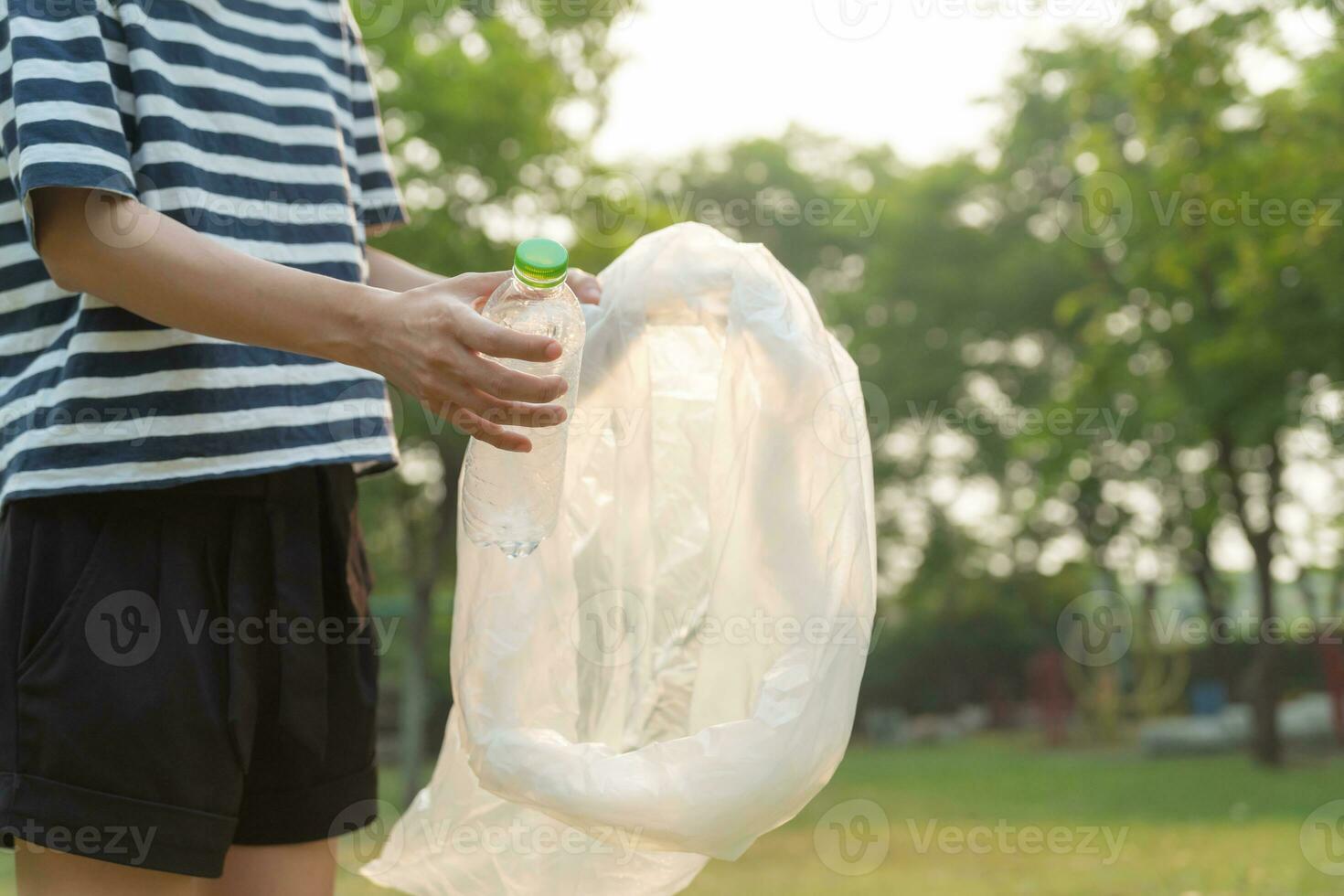 Save earth. Volunteer pick up trash garbage at the park and plastic bottles are difficult decompose prevent harm. Earth, Environment, Greening planet, reduce global warming, Save world ,pollution photo