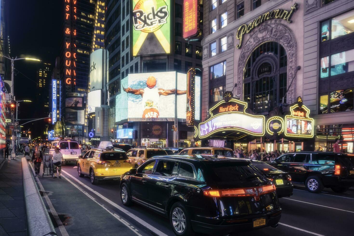 New York City, USA - August 9, 2019-People and tourists stroll among the lights and skyscrapers of Time Square in Manhattan during a summer night photo