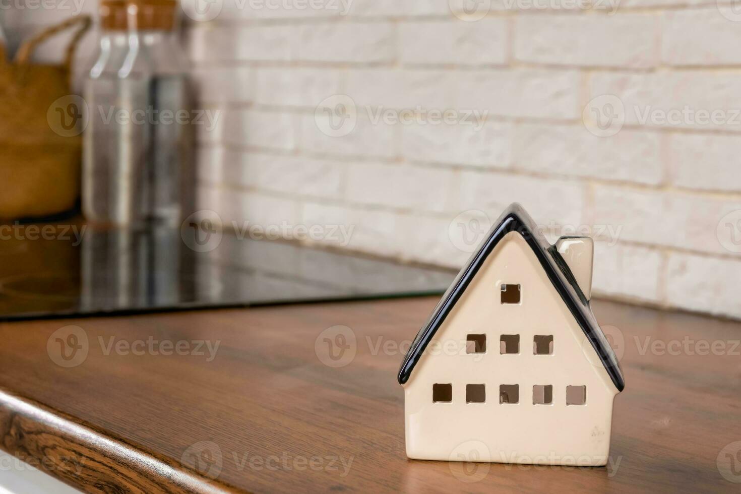 model of a house on the background of kitchen furniture. The concept of buying a house, mortgage real estate photo