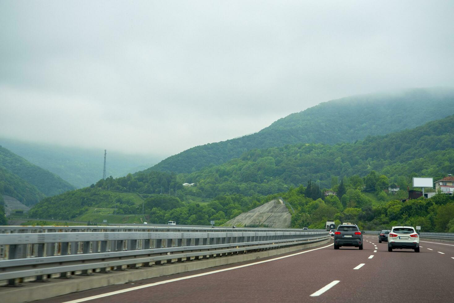 The car drives along a beautiful mountain road. photo