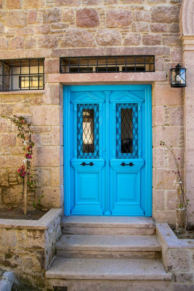 Blue double wooden door, well painted with windows. photo