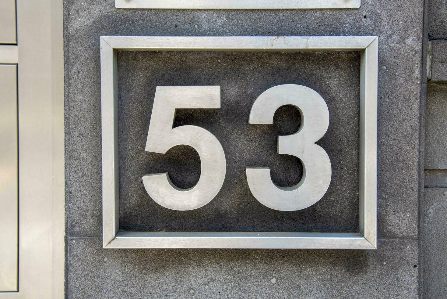 The plate with the number 53 is made of metal. photo