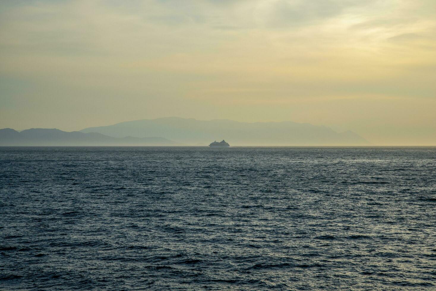 A cruise ship sails into the sunset on a summer day. photo