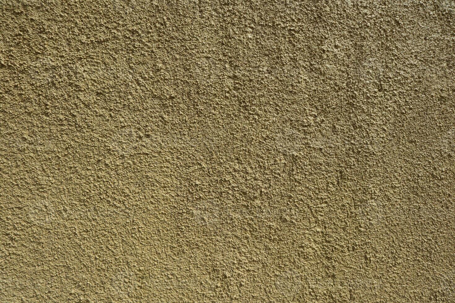 Textured background of a rough yellow wall photo