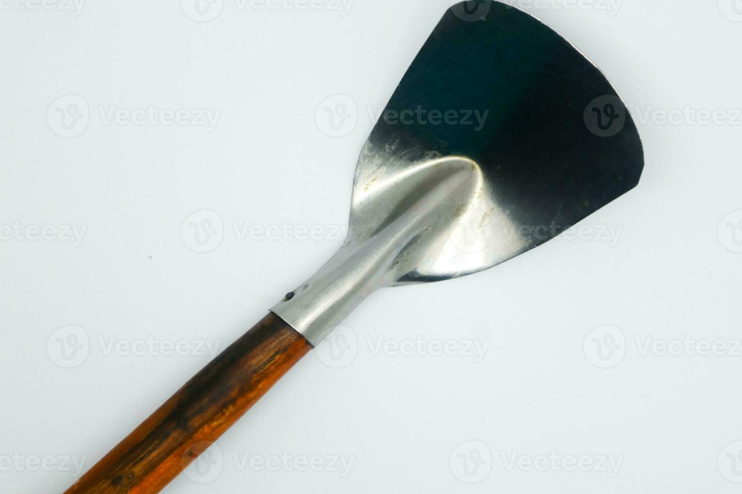 stainless steel spatula with wooden handle. cooking ware. isolated background in white photo