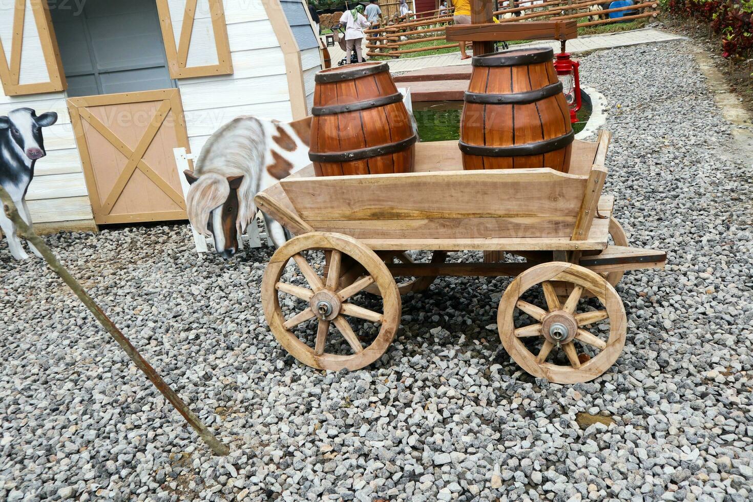 a wooden cart carrying a brown container with no contents photo