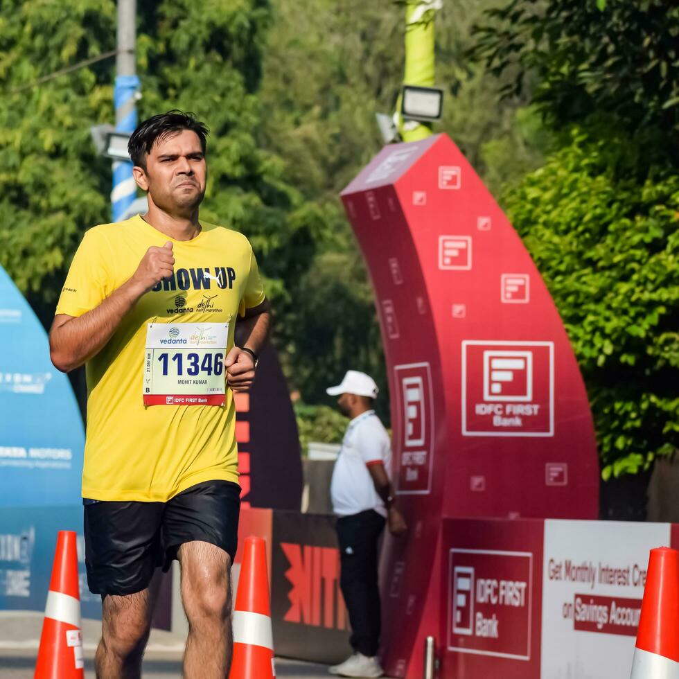 New Delhi, India - April 16 2023 - Vedanta Delhi Half Marathon race after covid in which marathon participants about to cross the finish line, Delhi Half Marathon 2022 photo