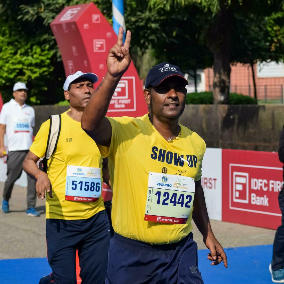 New Delhi, India - April 16 2023 - Vedanta Delhi Half Marathon race after covid in which marathon participants about to cross the finish line, Delhi Half Marathon 2022 photo