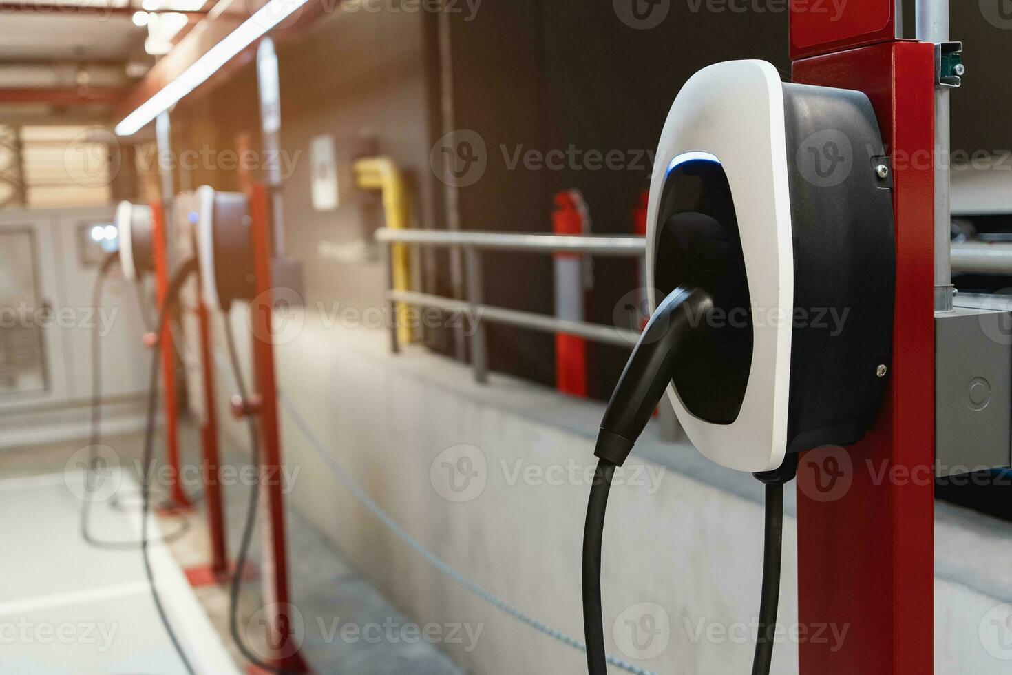 EV Car charging station for charge EV battery. Plug for vehicle with electric engine. EV charger. Clean energy. Charging point at car parking lot. Future transport technology modern car concept. photo