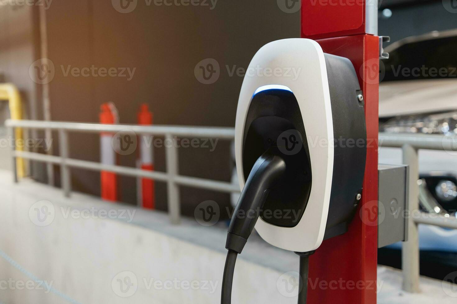 EV Car charging station for charge EV battery. Plug for vehicle with electric engine. EV charger. Clean energy. Charging point at car parking lot. Future transport technology modern car concept. photo