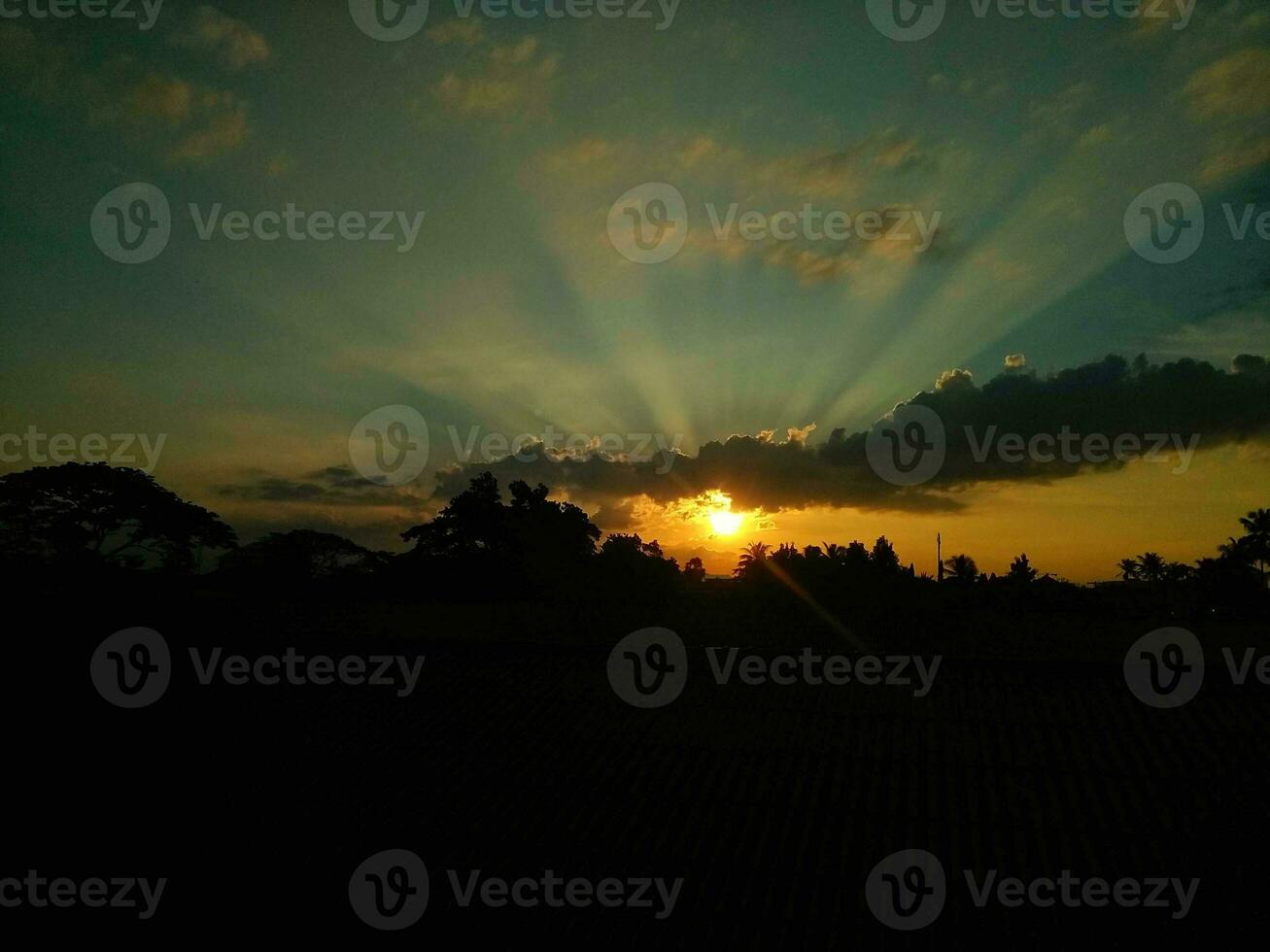 Sunset over the horizon in the evening background. Beautiful sky and clouds. Golden time. photo