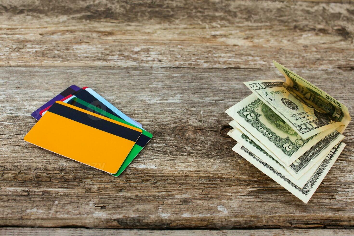 Credit card and dollars on wooden background. photo