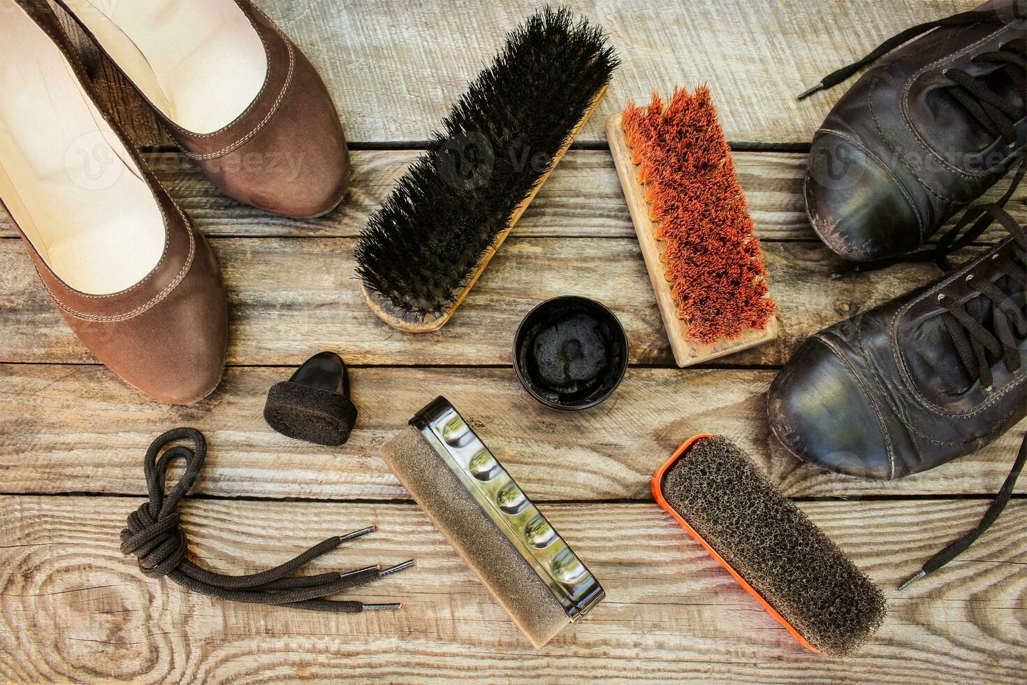 Women's shoes and care products for footwear on wooden background. photo