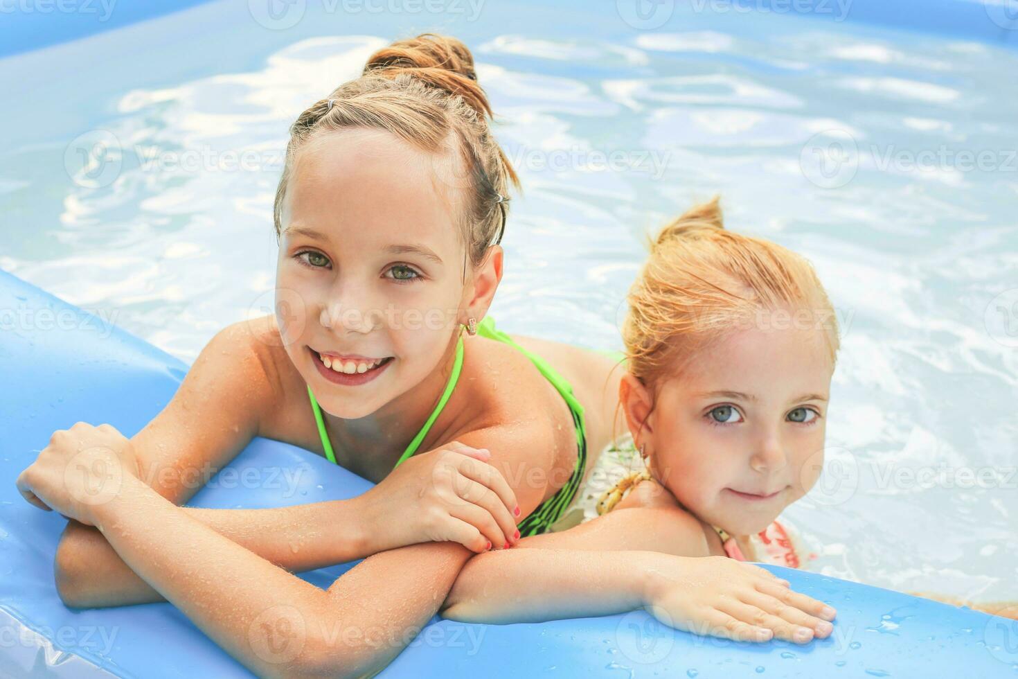 Girls swimming in the pool.  Toned image. photo