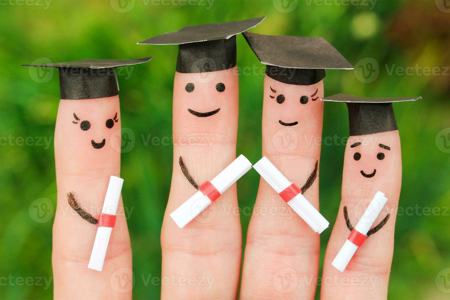 Finger art of students. Graduates holding their diploma after graduation. Toned image photo