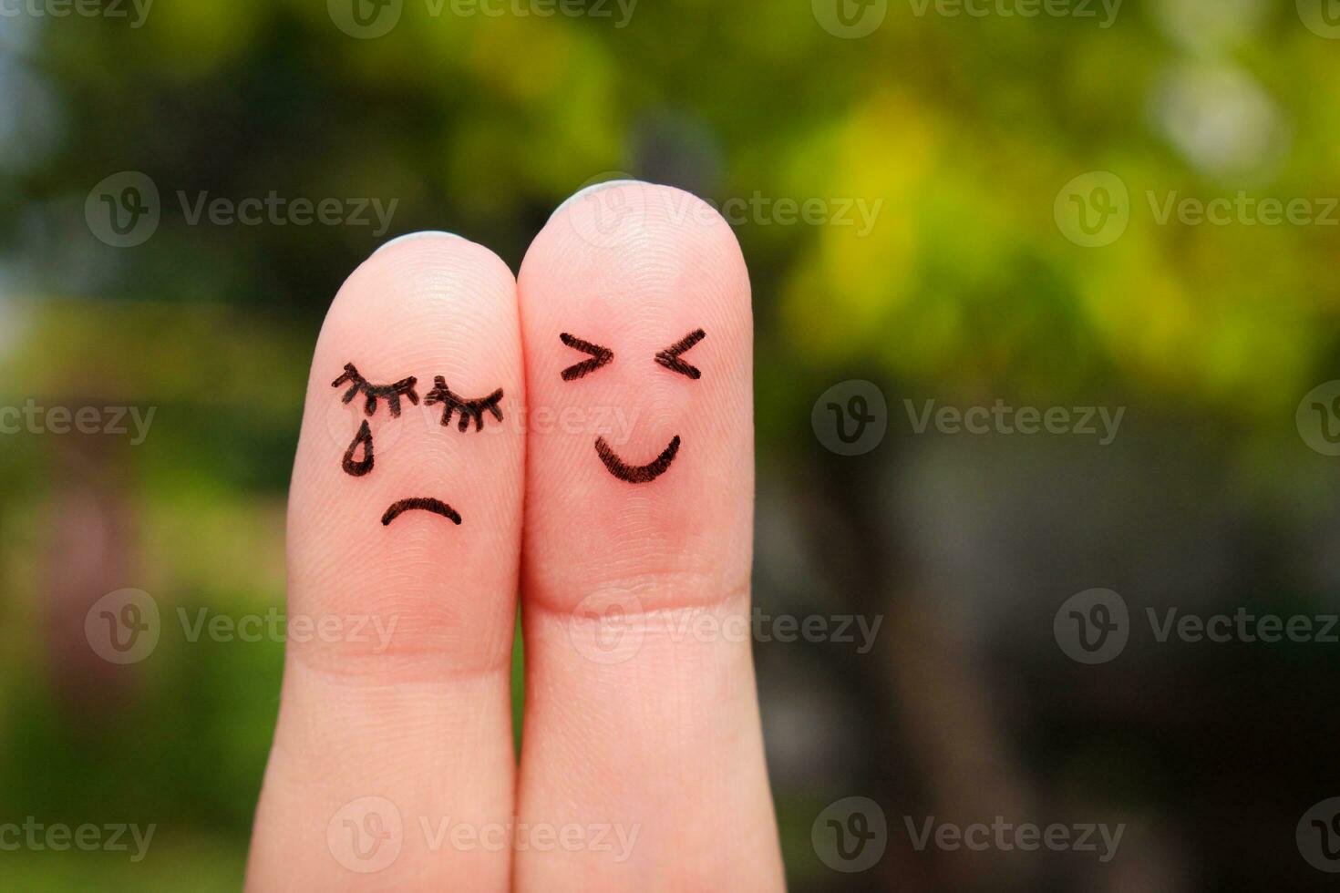 Finger art of couple. Woman cries, man is cheerful. photo