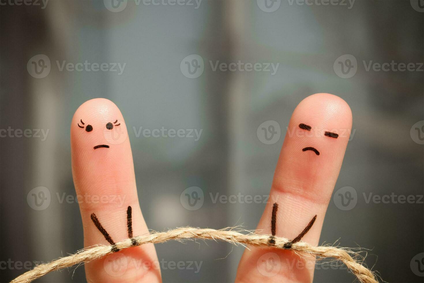 Finger art of couple. Woman and man pull rope. Couple quarreled, cannot solve the problem, a misunderstanding. photo