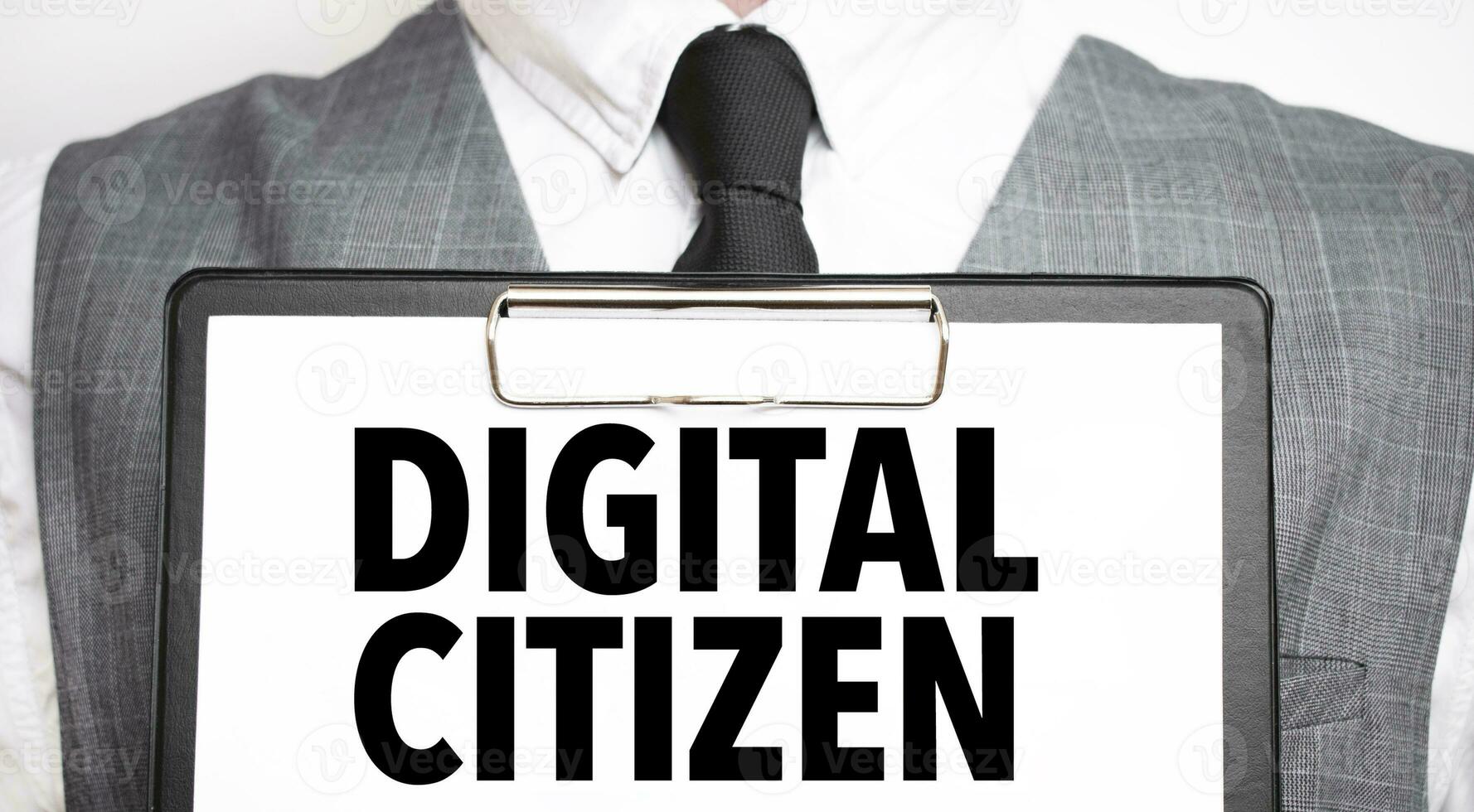 Businessman holding sheet of paper with a message DIGITAL CITIZEN photo