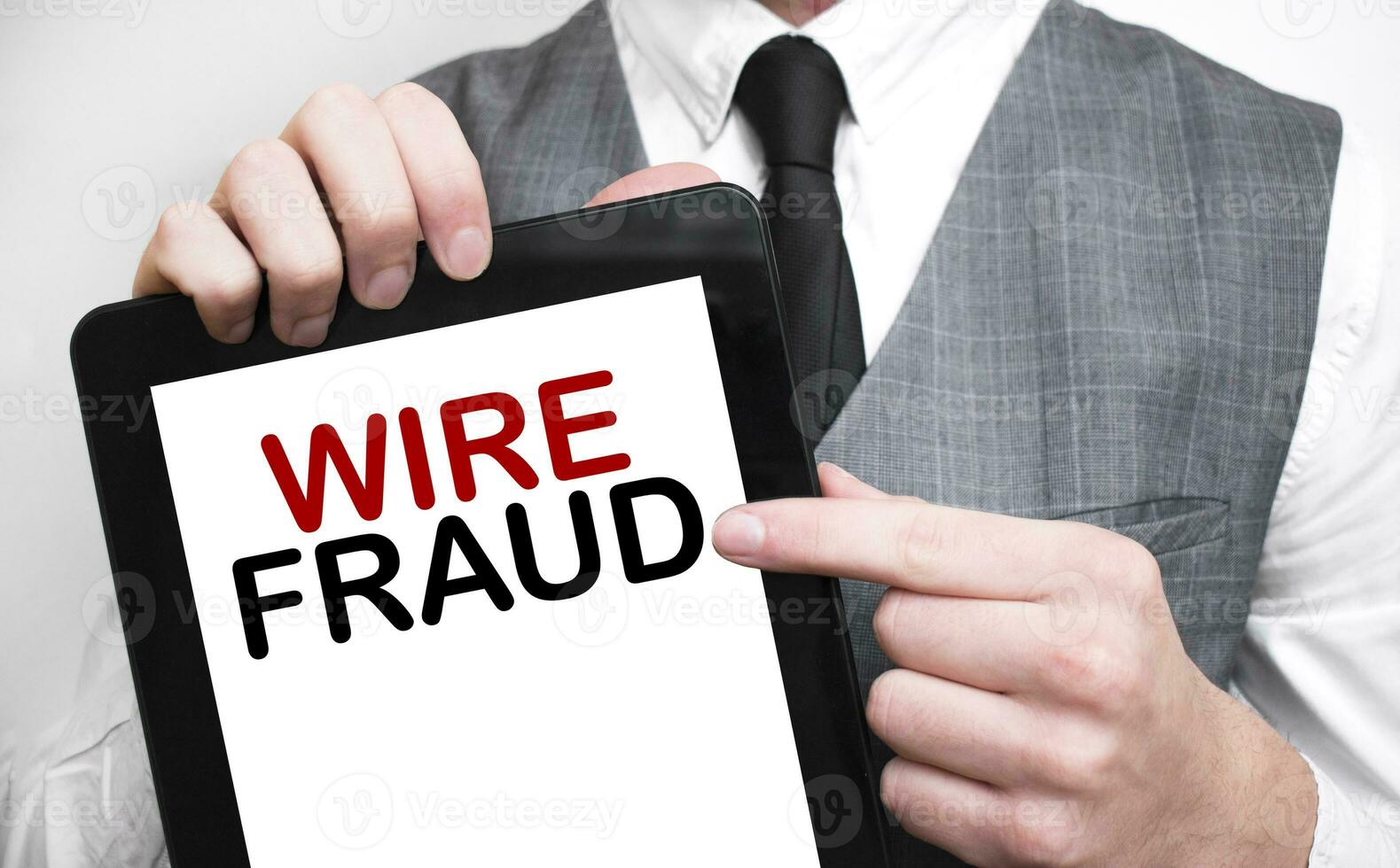 Businessman showing business concept on tablet standing in office WIRE FRAUD photo