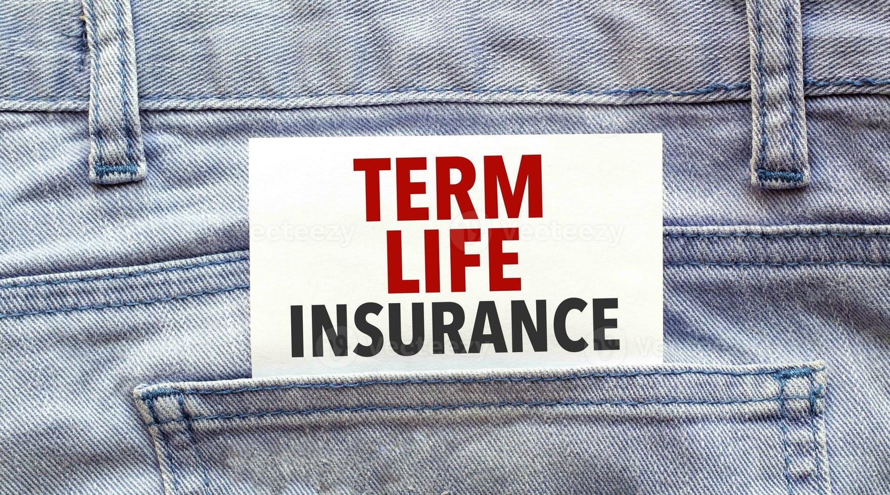 Text TERM LIFE INSURANCE on a white paper stuck out from jeans pocket. Business concept photo