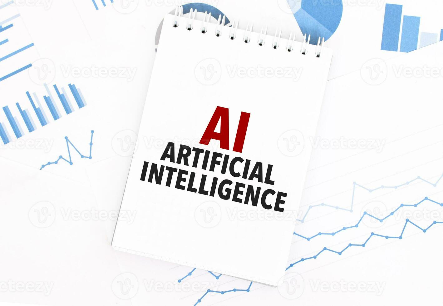 White notepad with text AI - Artificial Intelligence on the financial documentation. Finance and business concept photo