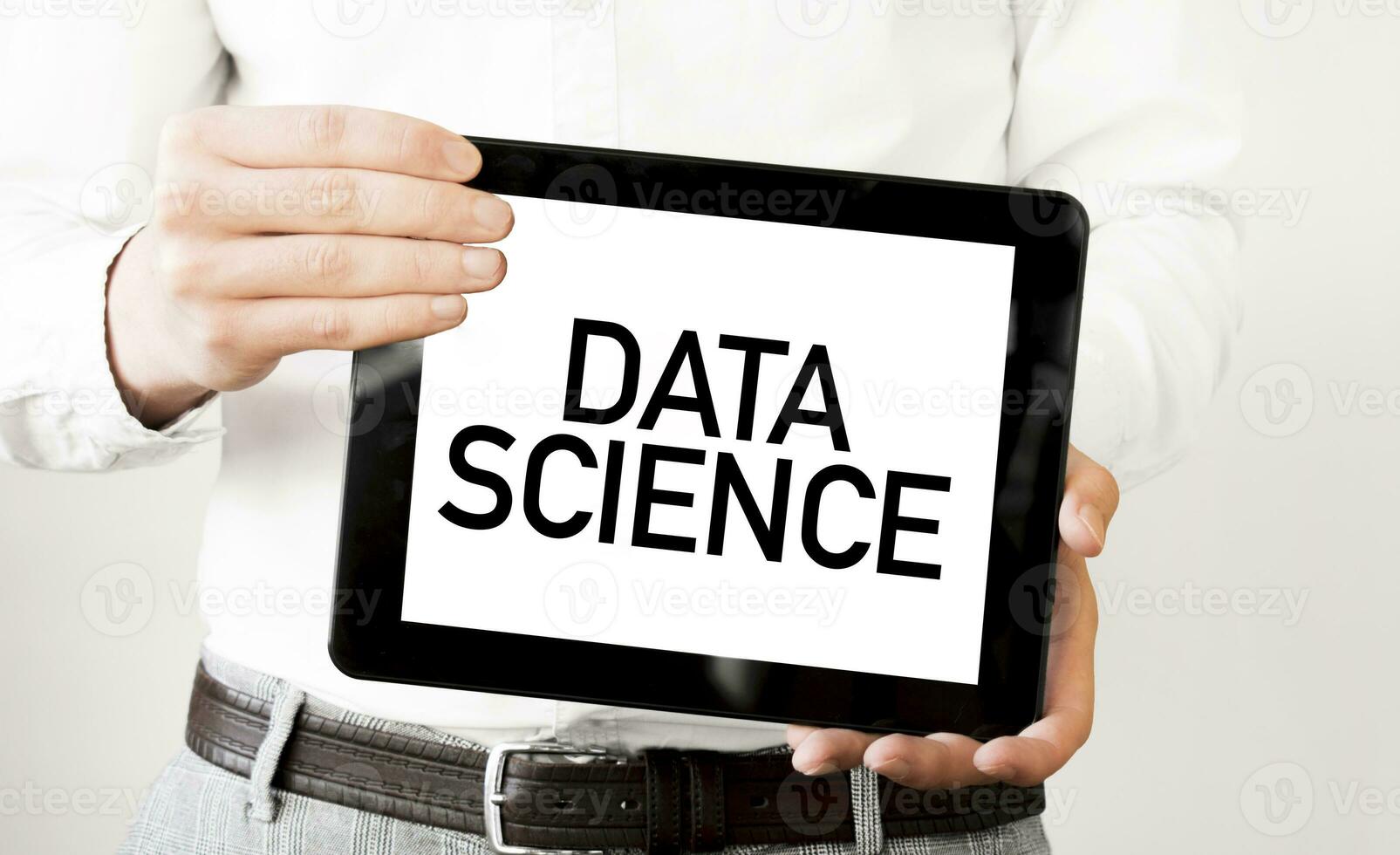 Text DATA SCIENCE on tablet display in businessman hands on the white background. Business concept photo