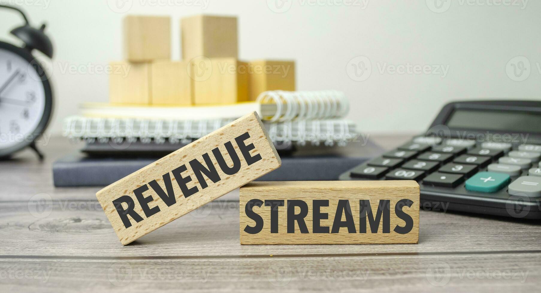 REVENUE STREAMS is shown on a conceptual photo using wooden blocks