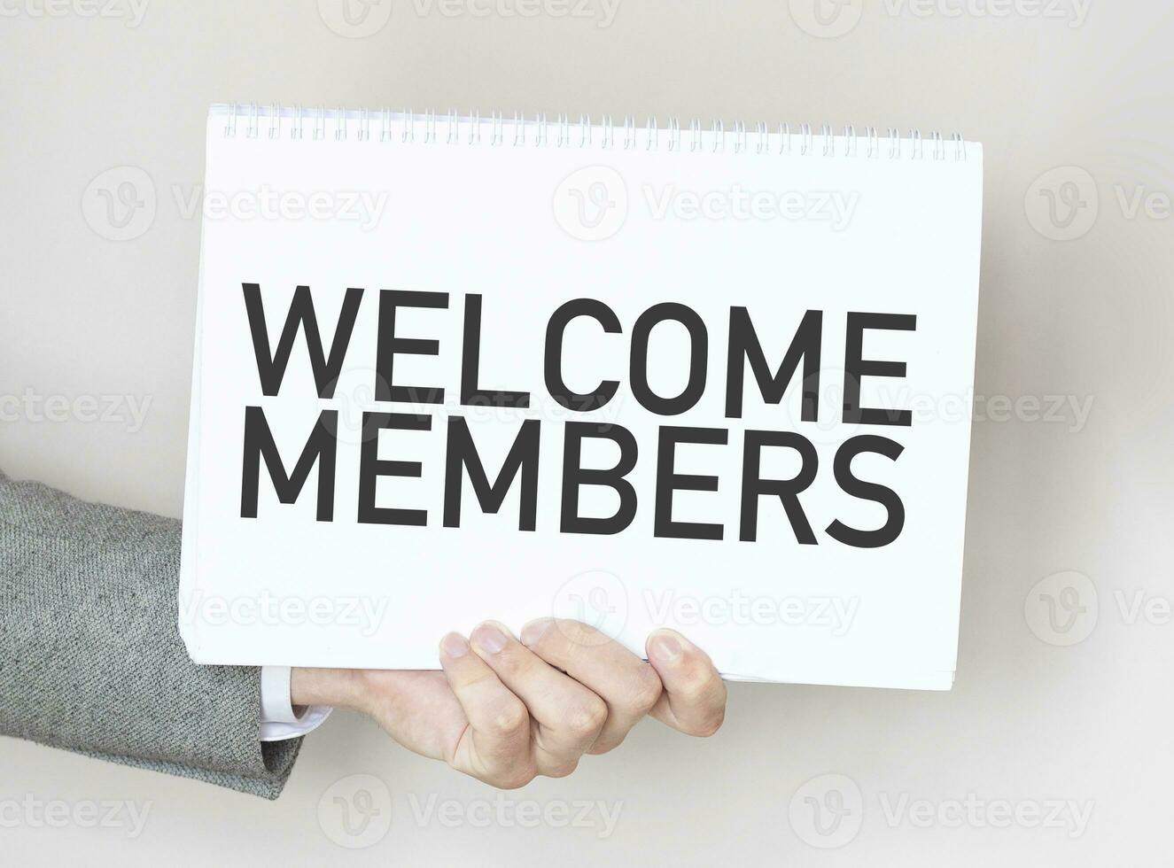 Businessman holding a card with text WELCOME MEMBERS photo