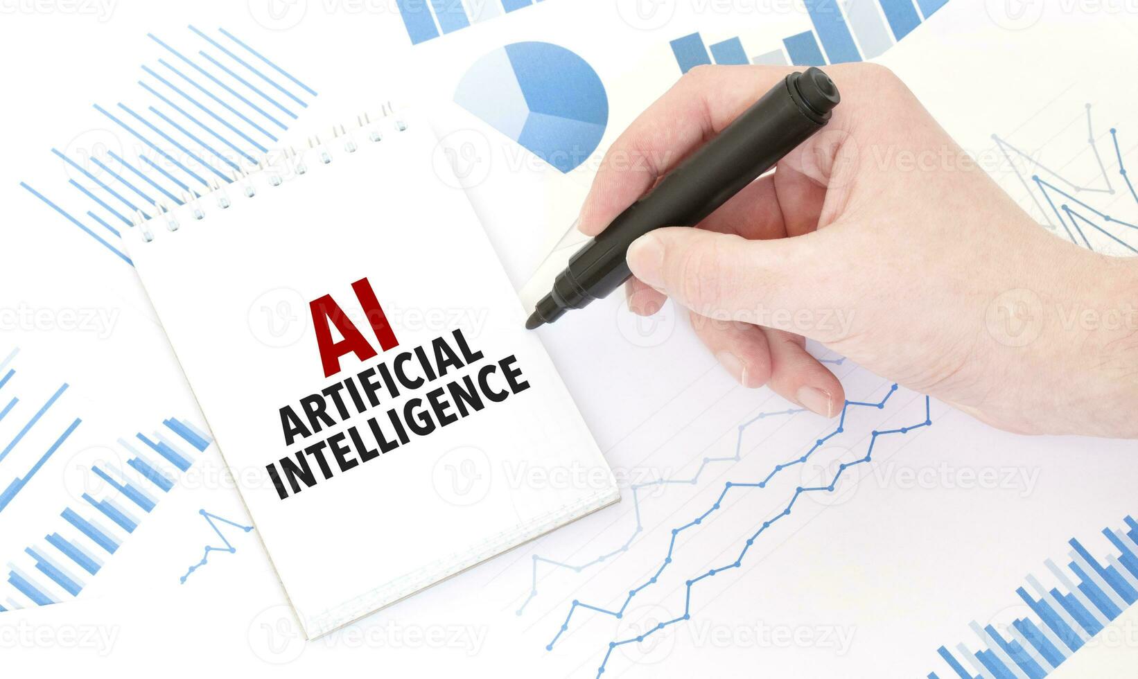 Businessman holding a black marker, notepad with text AI - Artificial Intelligence, business concept photo