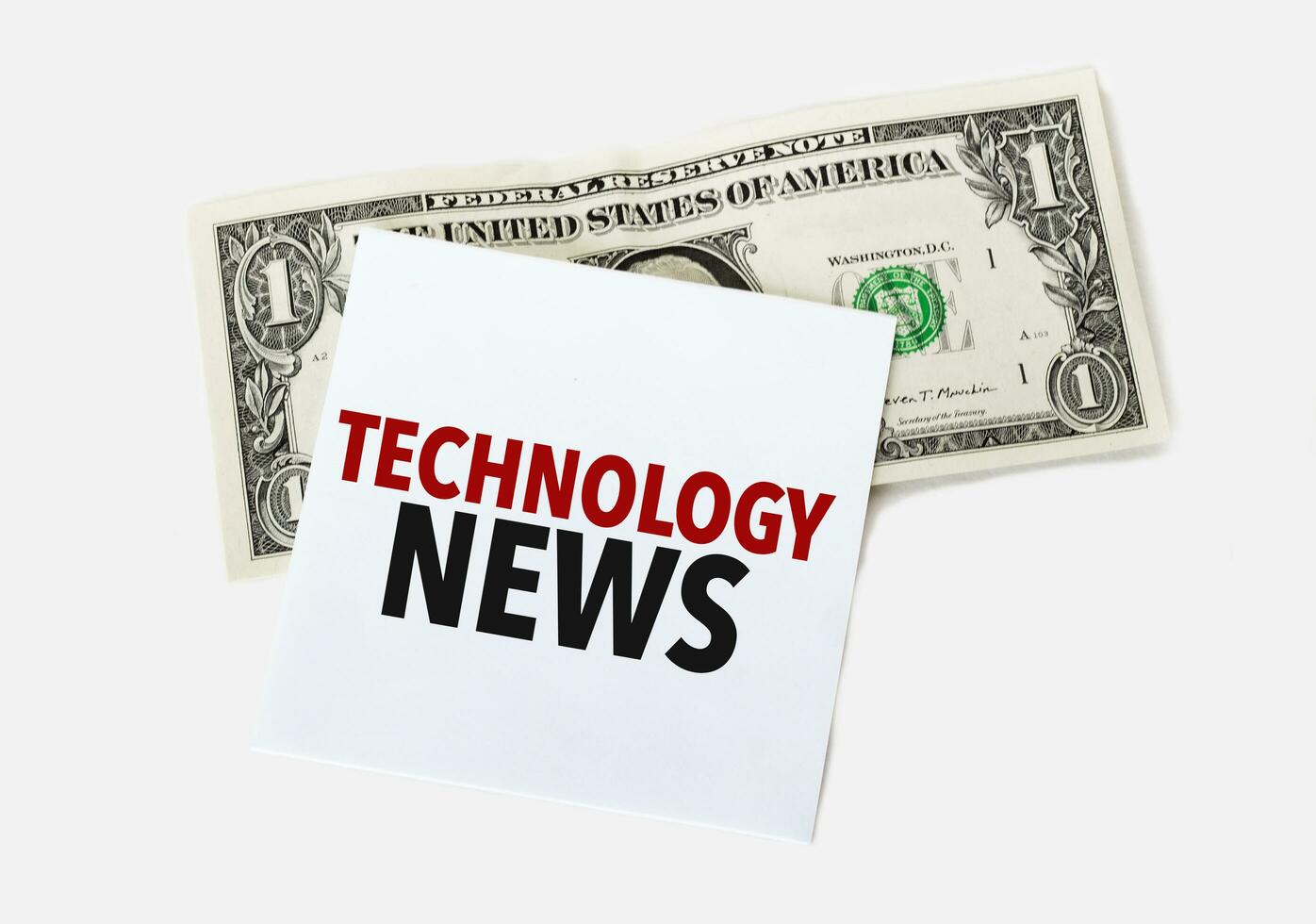 1 dollar bill and white notepad sheet on the white background. Text technology news photo