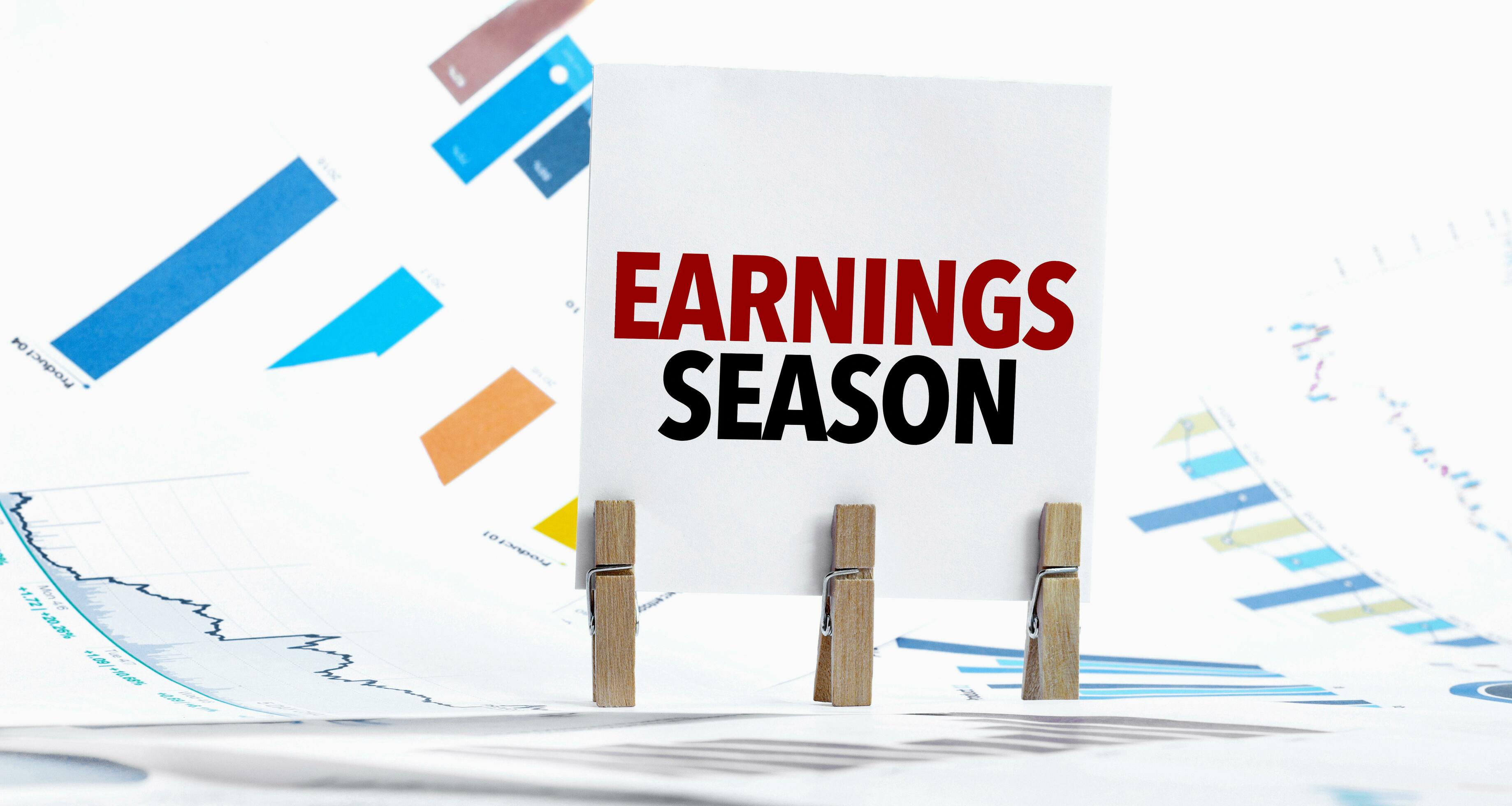 Text EARNINGS SEASON on paper sheet with chart, dice, spectacles, pen