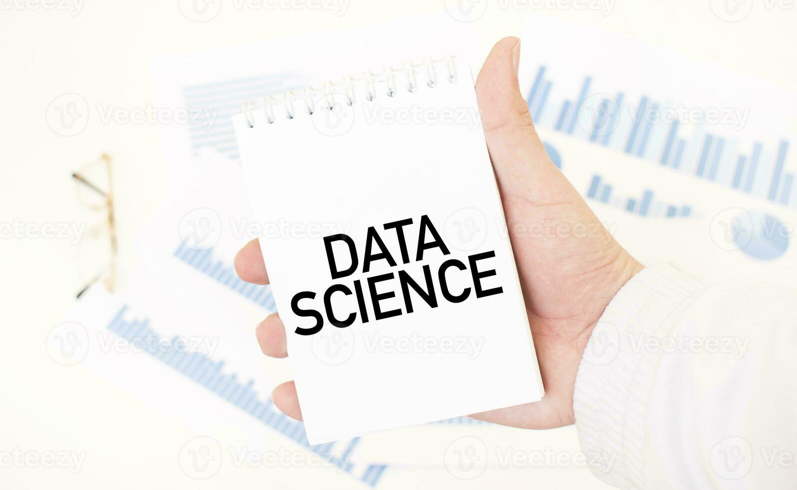 Businessman holding a white notepad with text DATA SCIENCE, business concept photo
