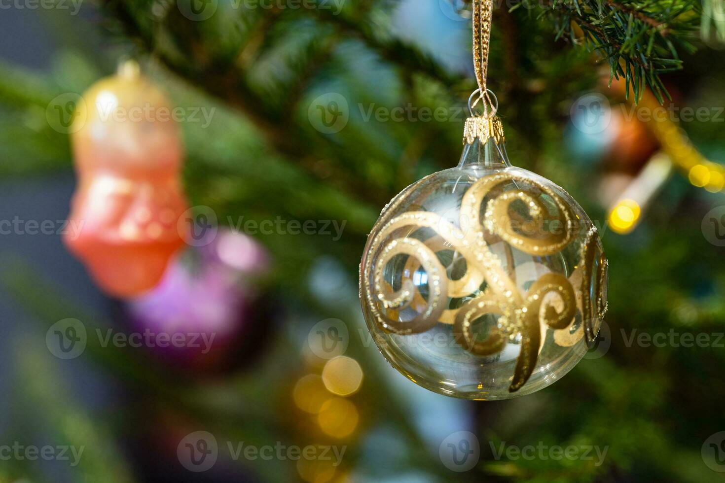 glass baubles on natural christmas tree close up photo