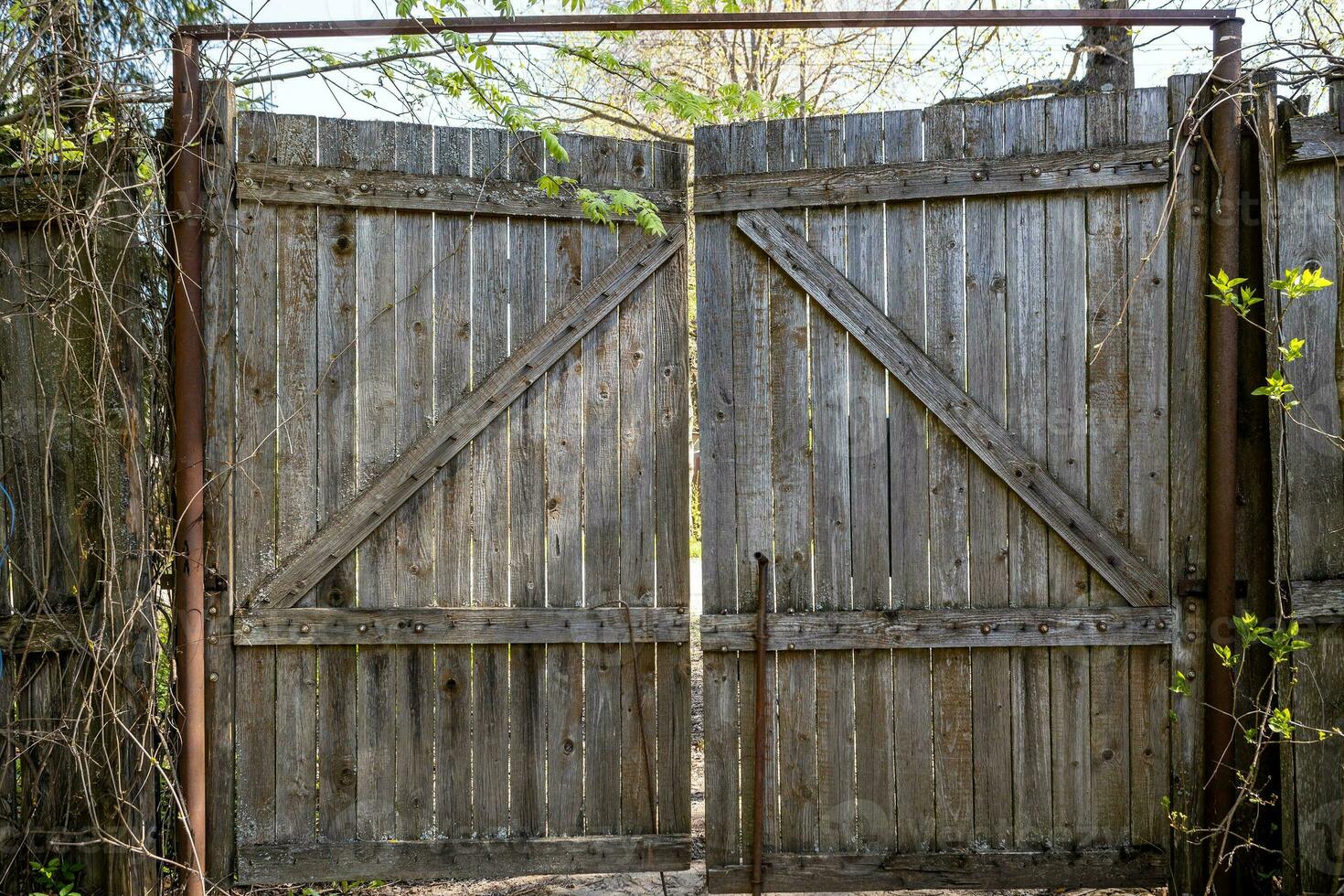old wooden gate made of planks in village yard photo