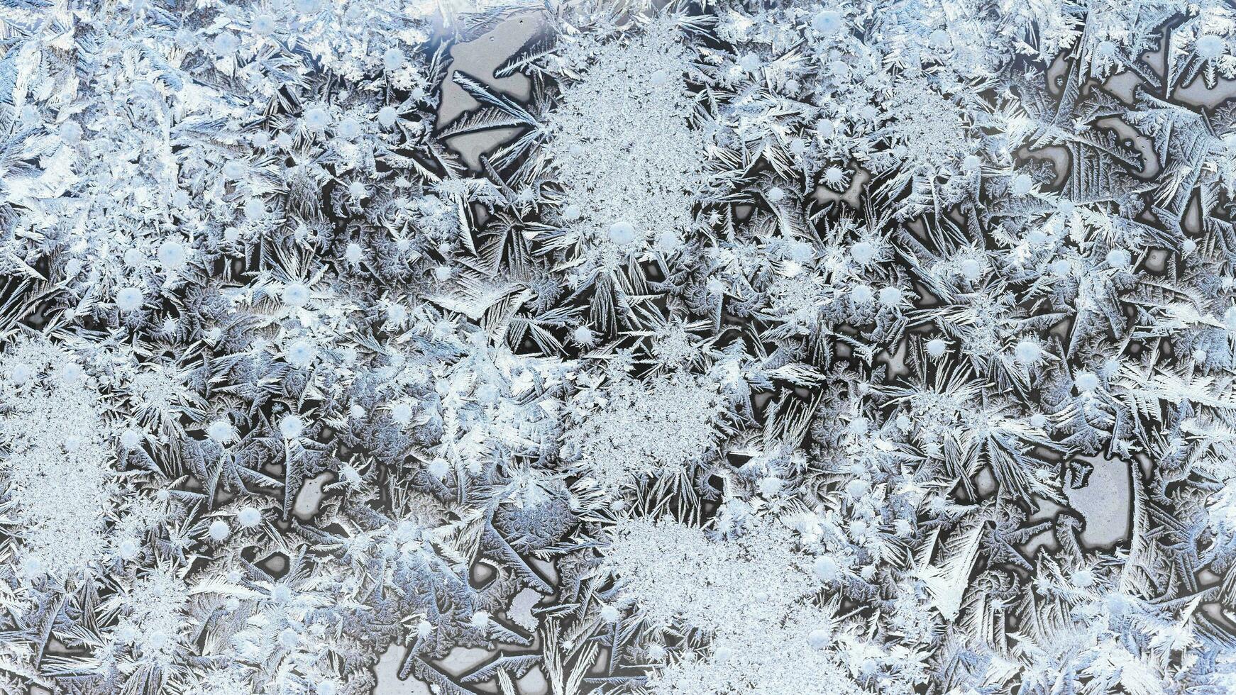frozen ice on surface on window glass close up photo