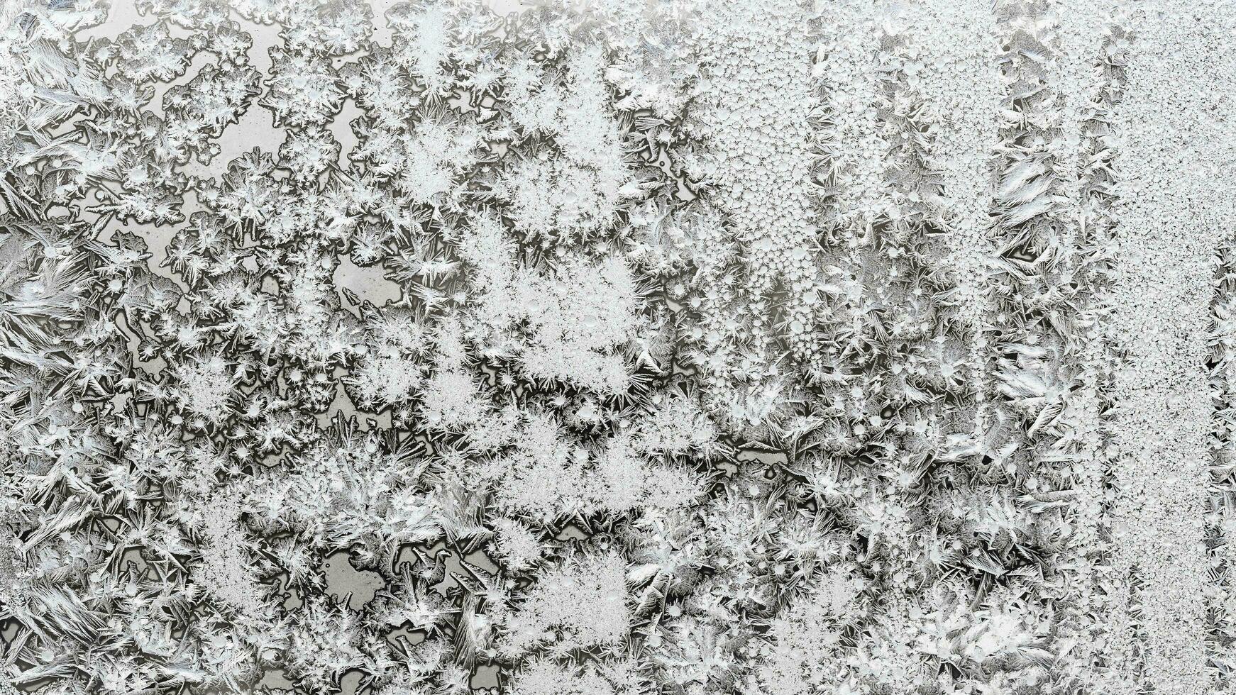 frozen pattern on surface on window glass close up photo