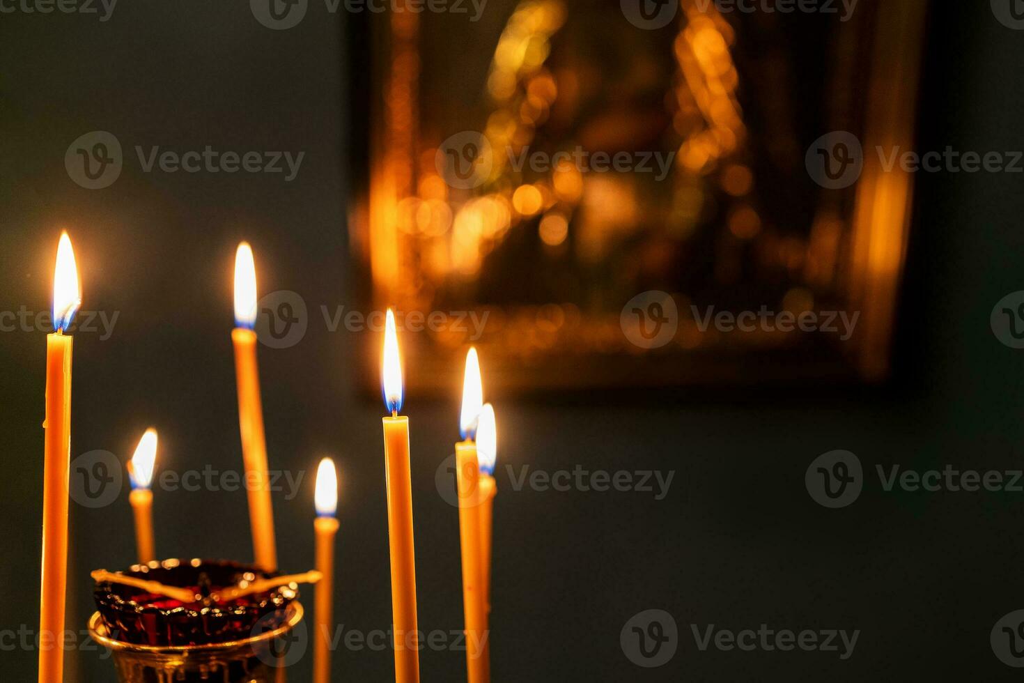 candles burn with blurred icon on background photo