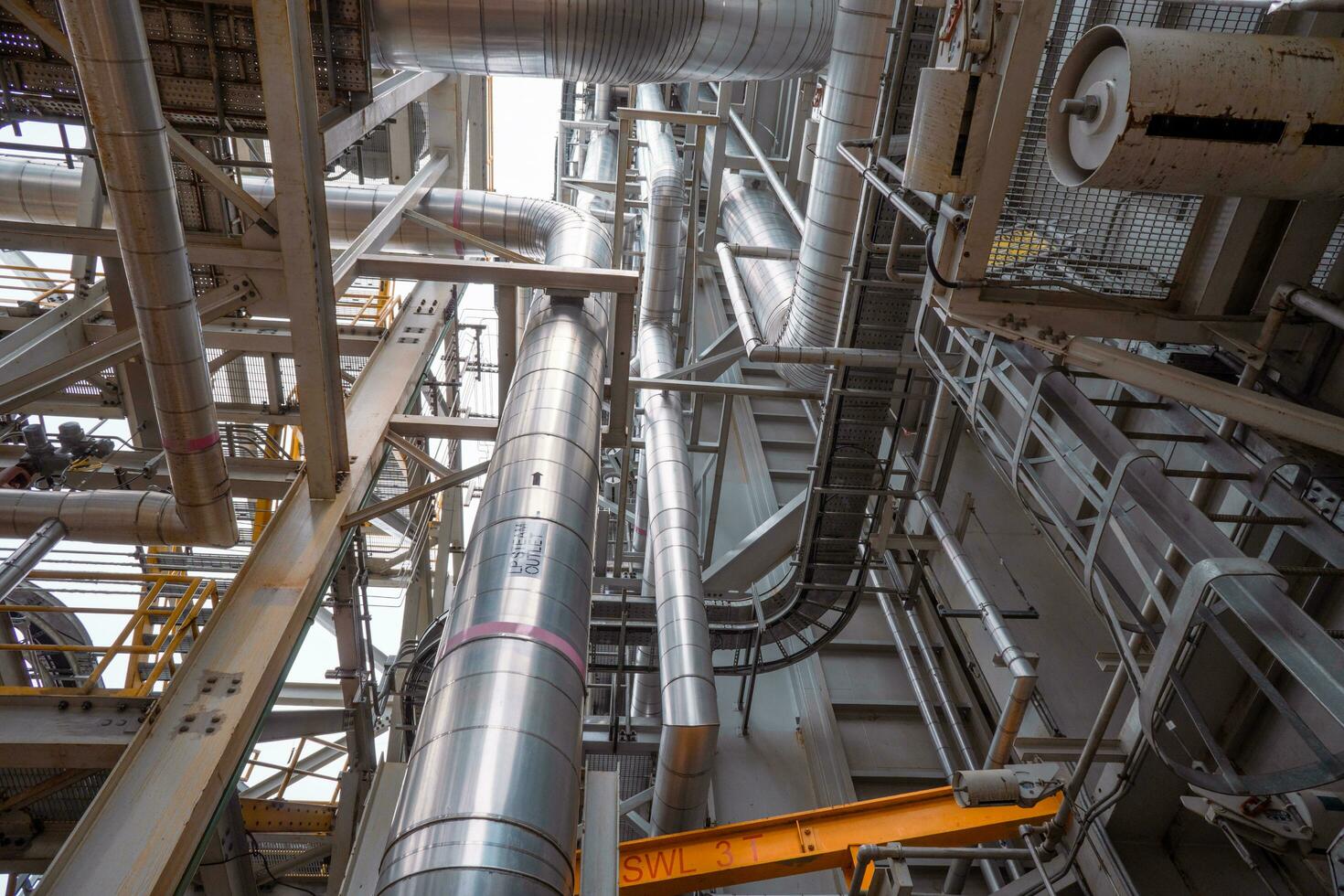 Heat recovery Steam Generator with pipe line, air intake and Up stair. The photo is suitable to use for industry background photography, power plant poster and electricity content media.